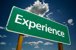 "Experience" Road Sign with dramatic clouds and sky.